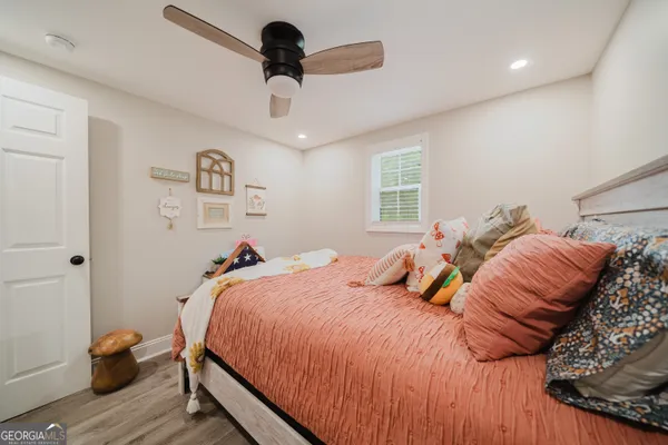 a bedroom with a bed and wooden floor