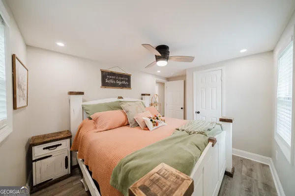 a bedroom with a bed and a night stand