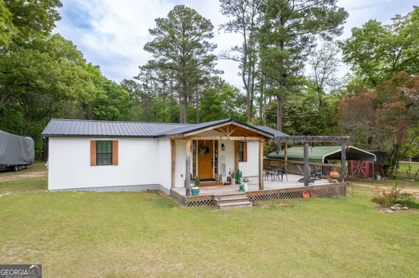 a front view of a house with swimming pool and porch