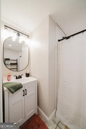 a bathroom with a sink vanity mirror and toilet