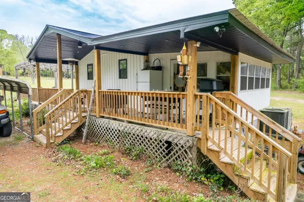 a view of a house with a wooden deck