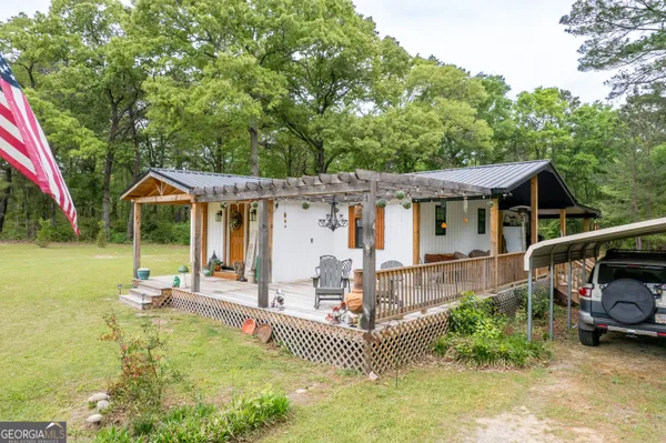 an outdoor view of house with swimming pool and furniture