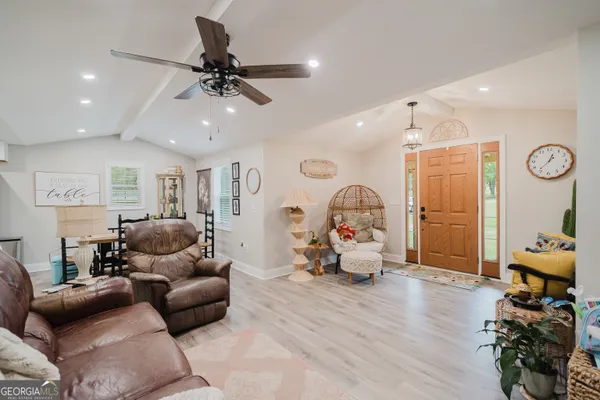 a living room with furniture and a chandelier