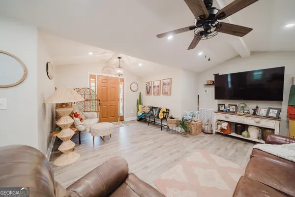 a living room with furniture and a flat screen tv