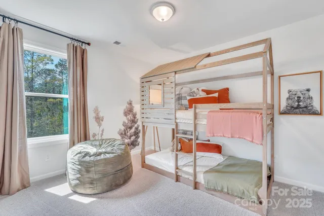 a living room with furniture and floor to ceiling windows
