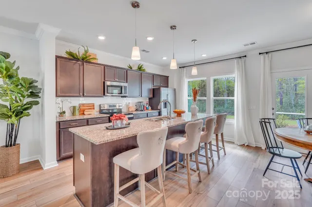 a kitchen with a table and chairs in it