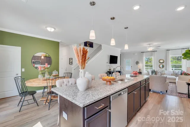 a kitchen with a table chairs and wooden floor