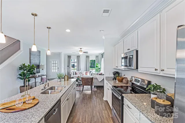 a kitchen with sink stove and cabinets