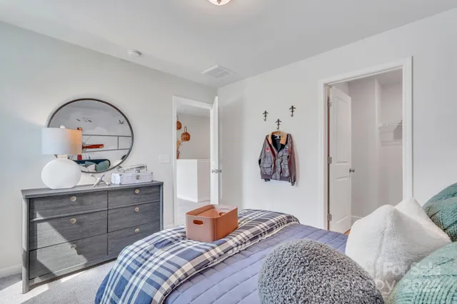 a bedroom with a bed and a dresser