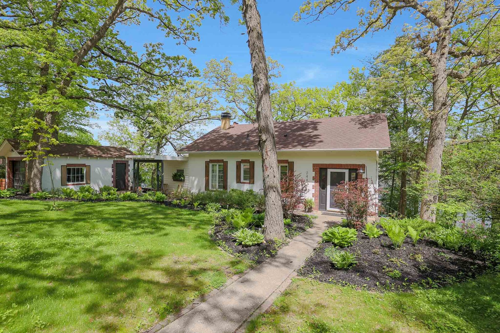 244 Indian Trail Lake In The Hills, IL 60156 - Photo 1 of 52 a front view of a house with a garden