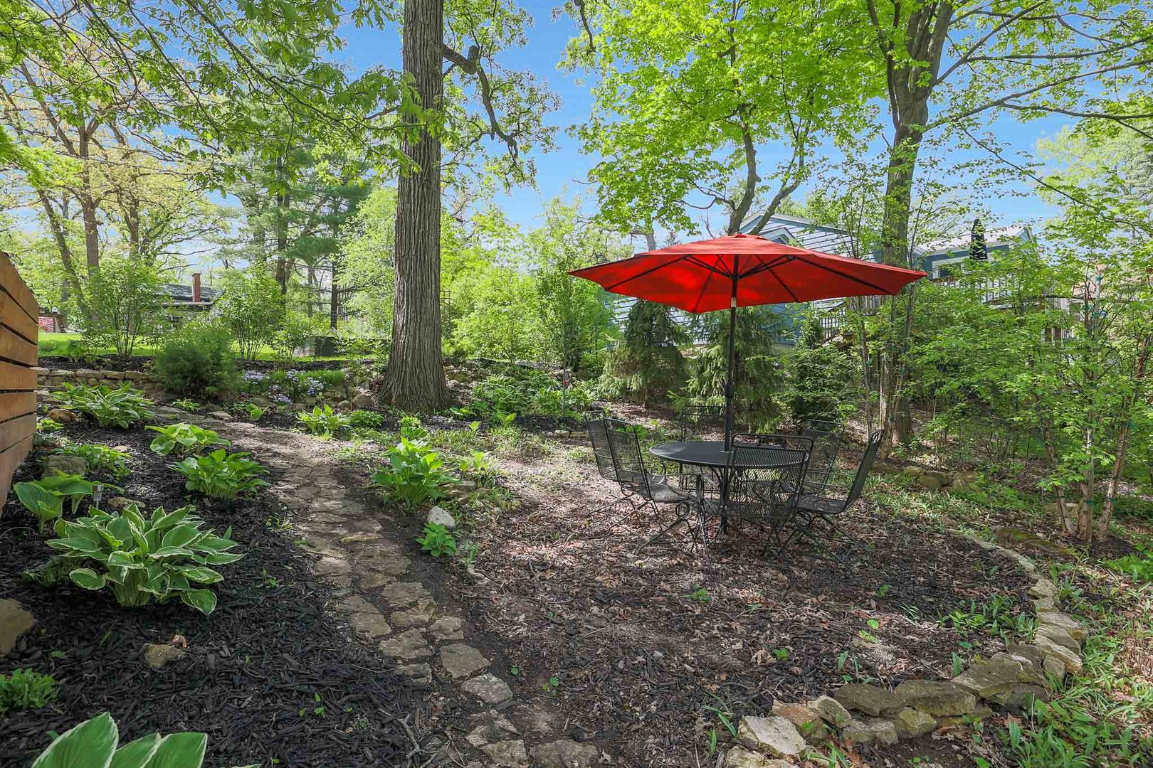 244 Indian Trail Lake In The Hills, IL 60156 - Photo 35 of 52 a view of a backyard with a table and chairs under an umbrella