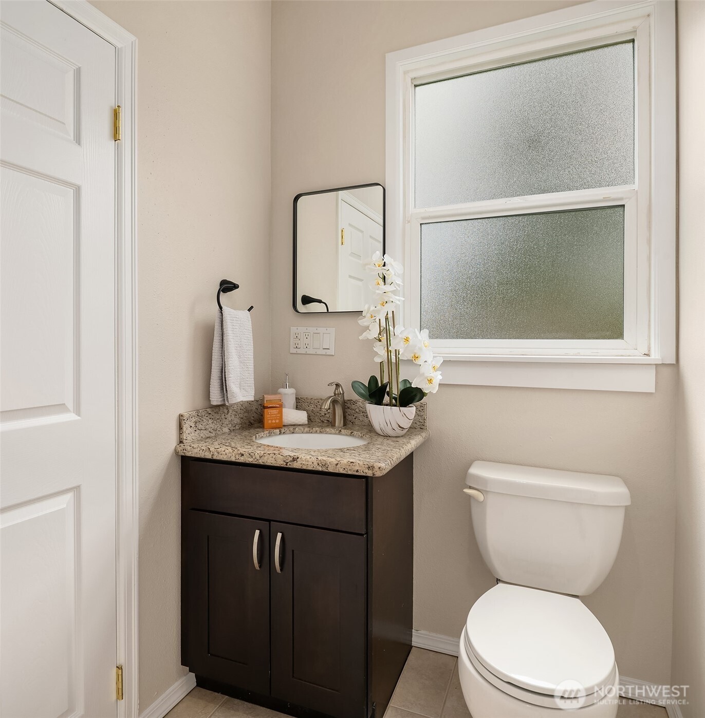 1532 Maple Street Everett, WA 98201 - Photo 18 of 39 a bathroom with a granite countertop toilet a sink and a mirror