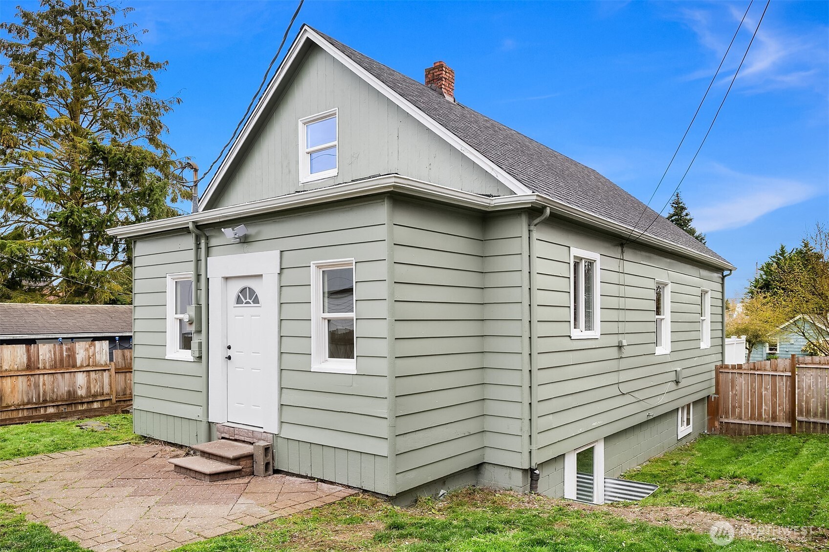 1532 Maple Street Everett, WA 98201 - Photo 34 of 39 a view of a white house with a small yard and wooden fence
