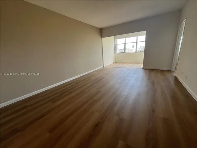a room with a table and white cabinet