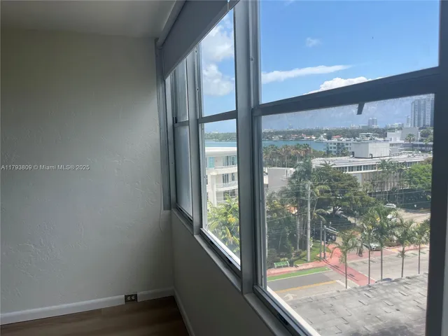 a view of a glass door with a yard from a window