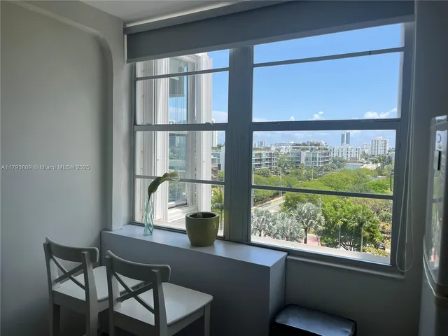 a view of a room with wooden floor and windows