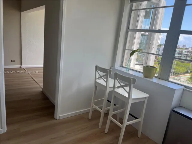 a view of wooden floor and brick walls