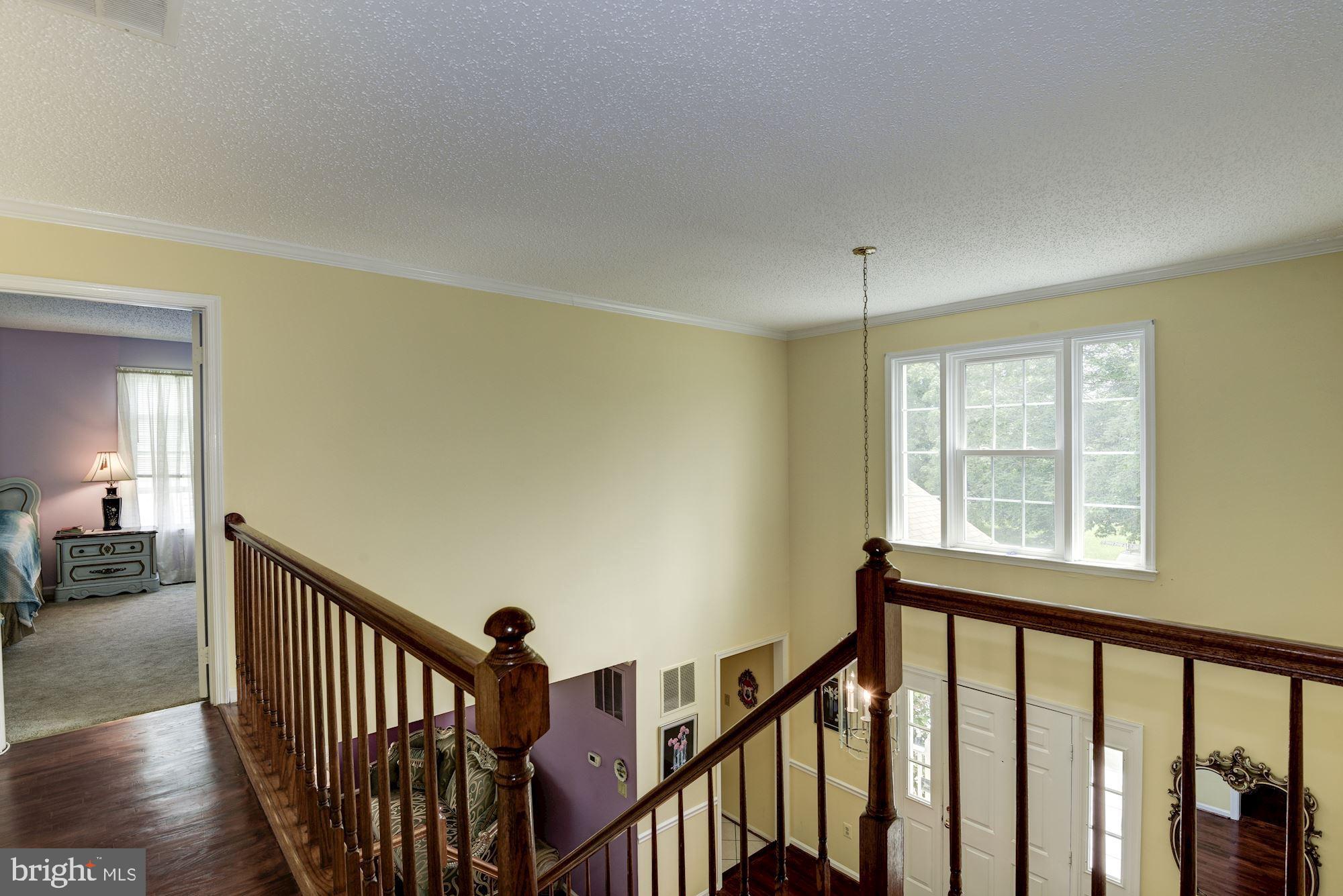 13509 Stockbridge Court Silver Spring, MD 20906 - Photo 22 of 35 a view of an empty room with wooden floor and a window