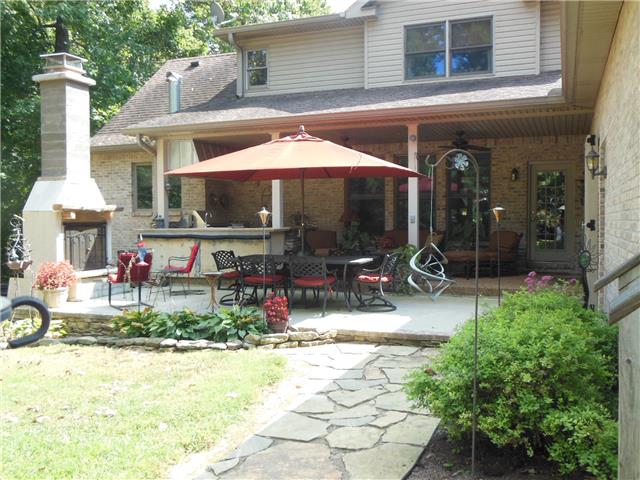 4168 Old Coopertown Road Springfield, TN 37172 - Photo 16 of 20 This back view shows the wrought iron table and chairs, the fireplace (works but he's putting stone around it), the covered patio and kitchen, lots of concrete and stone pavers, such a welcoming area.