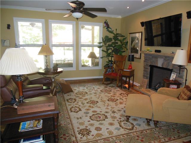 4168 Old Coopertown Road Springfield, TN 37172 - Photo 4 of 20 Really nice living room with fireplace, lots of natural light and a view of the outdoor entertainment area.