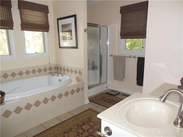 4168 Old Coopertown Road Springfield, TN 37172 - Photo 10 of 20 Tiled master bath has separate jetted tub and shower. Plenty of room for a couple to get ready in the morning