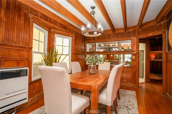 a dining room with furniture window and wooden floor