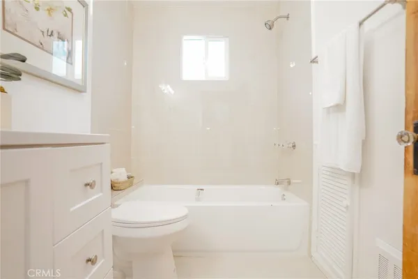 a bathroom with a toilet and a bathtub