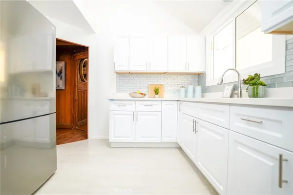 a kitchen with a sink a refrigerator and a stove