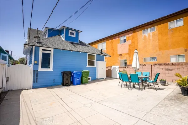 a view of a patio with a table and chairs