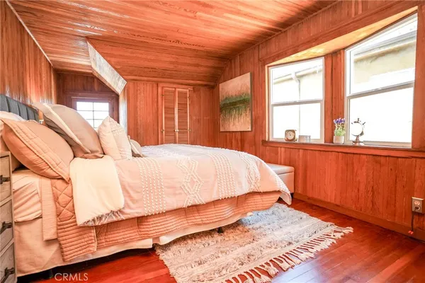 a large bed sitting in a bedroom next to a window