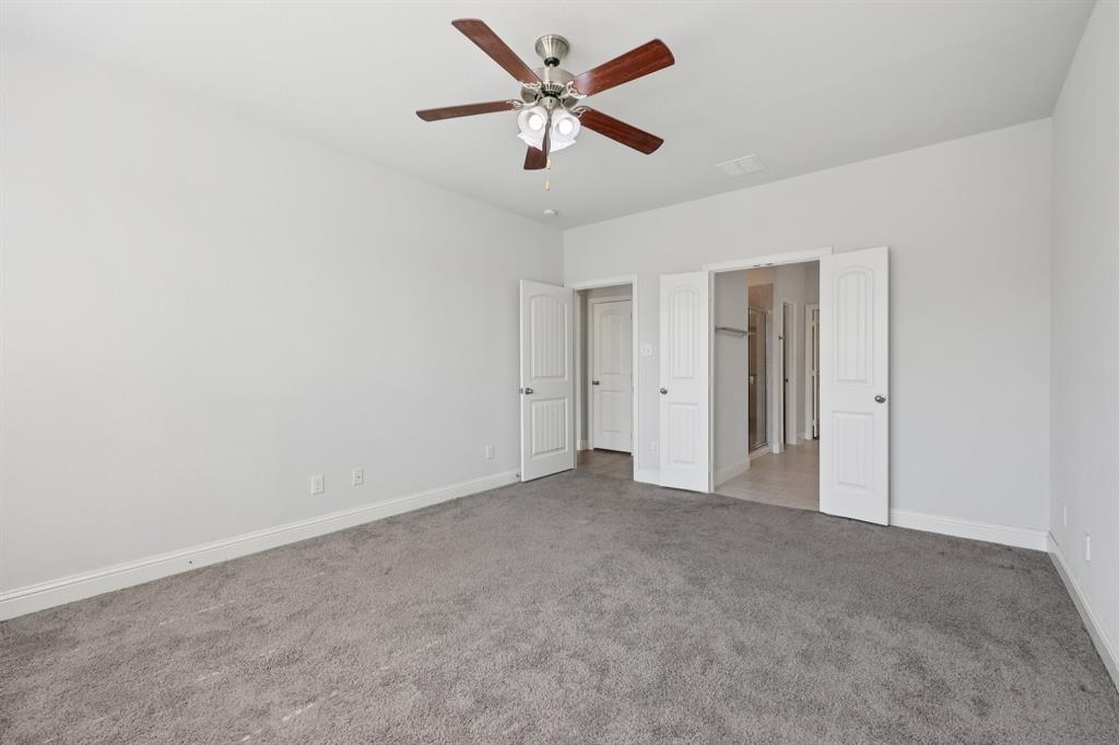 1205 Templin Avenue Forney, TX 75126 - Photo 16 of 40 an empty room with closet and a ceiling fan