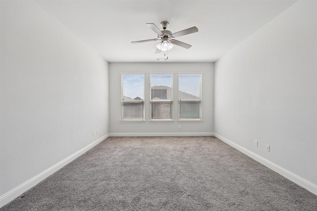 1205 Templin Avenue Forney, TX 75126 - Photo 17 of 40 an empty room with chandelier fan and windows