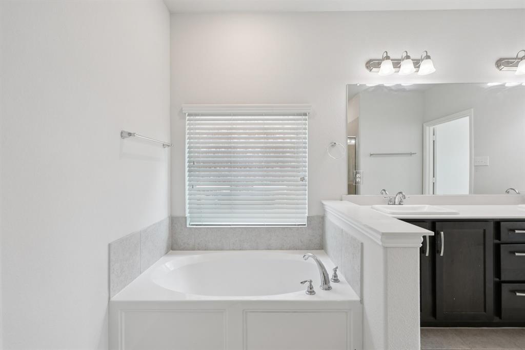 1205 Templin Avenue Forney, TX 75126 - Photo 20 of 40 a bathroom with a bathtub and a sink
