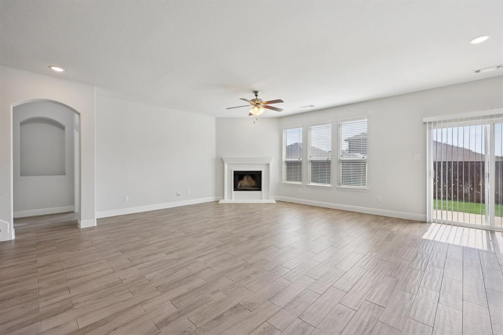 1205 Templin Avenue Forney, TX 75126 - Photo 2 of 40 an empty room with wooden floor and windows