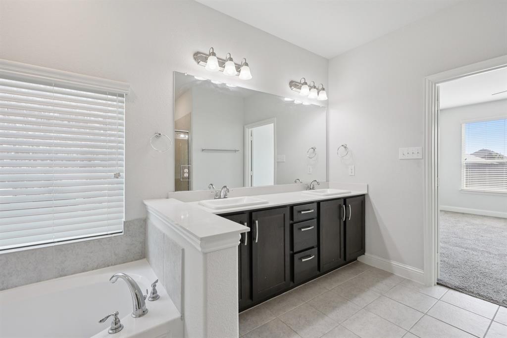 1205 Templin Avenue Forney, TX 75126 - Photo 21 of 40 a spacious bathroom with a sink double vanity and a mirror