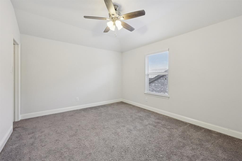 1205 Templin Avenue Forney, TX 75126 - Photo 23 of 40 an empty room with a window and a fan