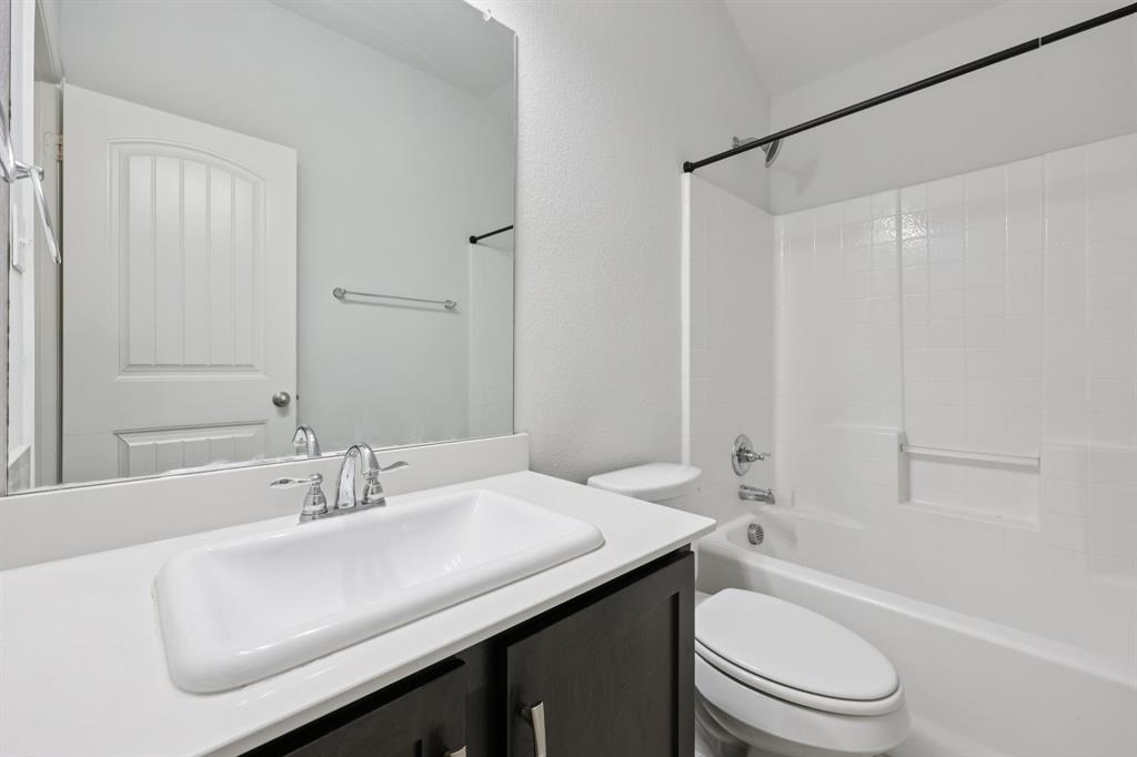 1205 Templin Avenue Forney, TX 75126 - Photo 25 of 40 a bathroom with a sink a toilet and shower