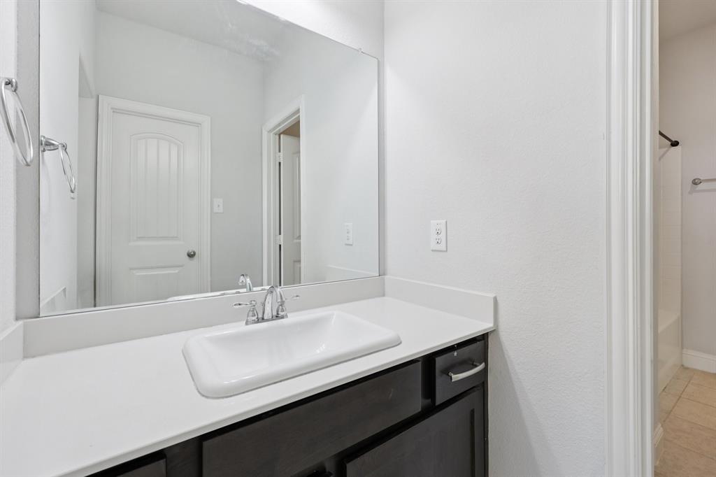 1205 Templin Avenue Forney, TX 75126 - Photo 31 of 40 a sink with a mirror