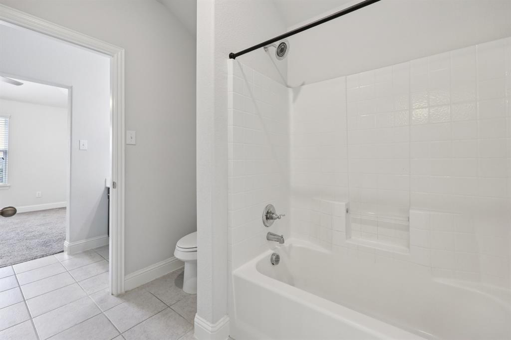 1205 Templin Avenue Forney, TX 75126 - Photo 33 of 40 a bathroom with a bathtub and a shower