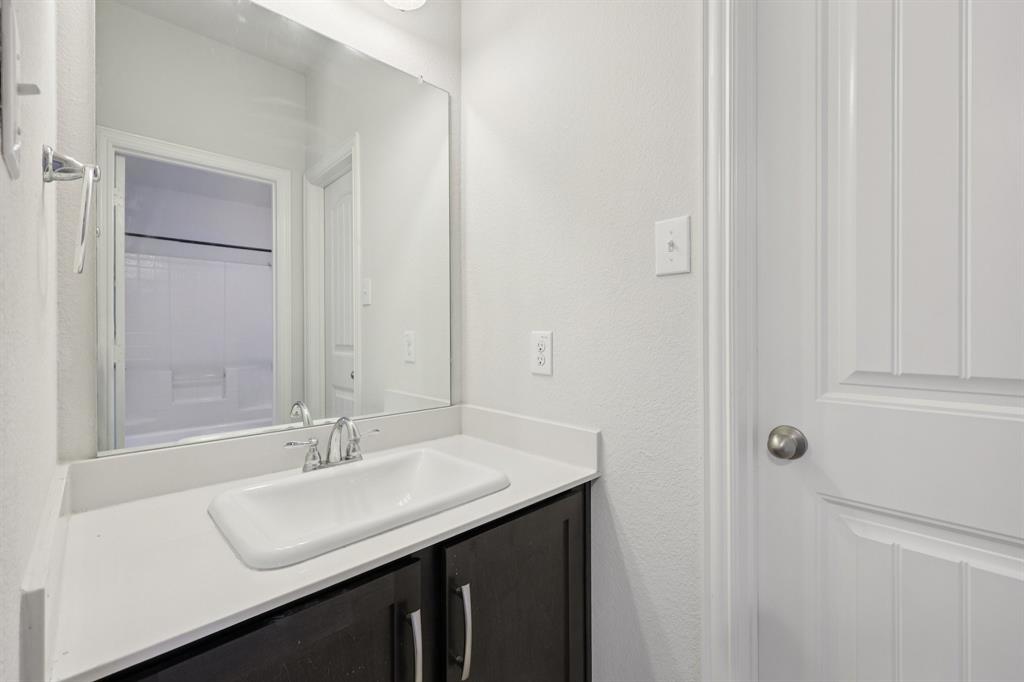1205 Templin Avenue Forney, TX 75126 - Photo 34 of 40 a bathroom with a sink and a mirror