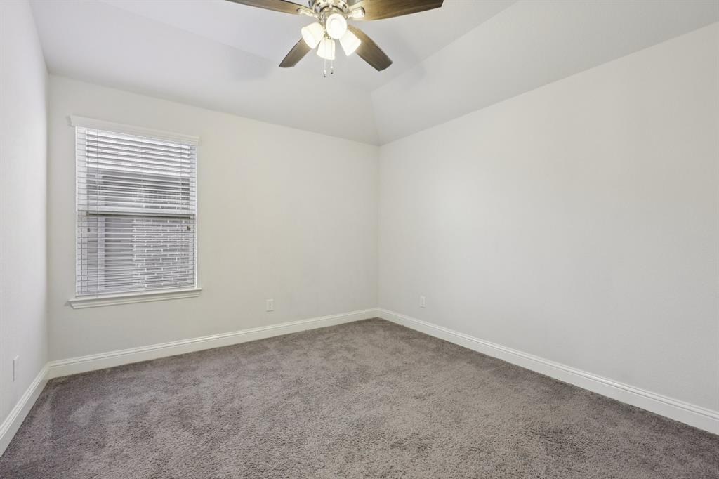 1205 Templin Avenue Forney, TX 75126 - Photo 36 of 40 an empty room with a chandelier fan and windows