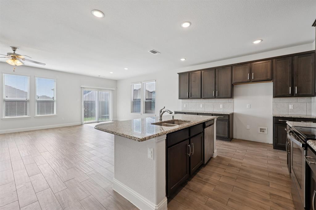 1205 Templin Avenue Forney, TX 75126 - Photo 5 of 40 a kitchen with stainless steel appliances granite countertop a sink stove and refrigerator