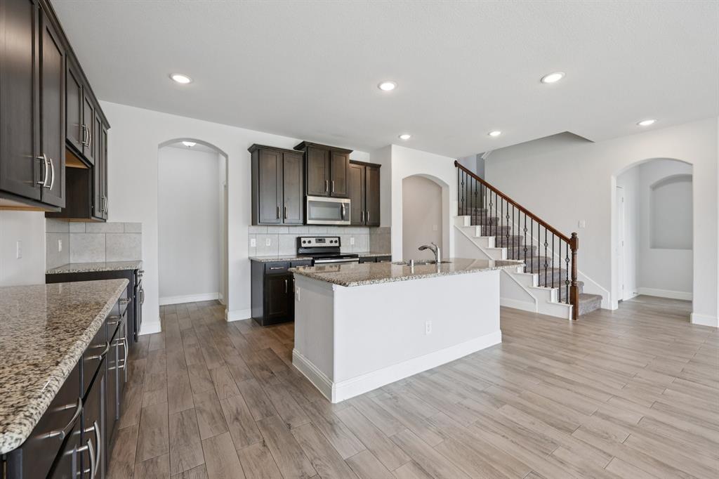 1205 Templin Avenue Forney, TX 75126 - Photo 7 of 40 a view of kitchen with microwave stove refrigerator and cabinets