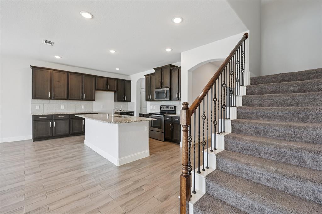 1205 Templin Avenue Forney, TX 75126 - Photo 10 of 40 a view of kitchen with cabinets and wooden floor