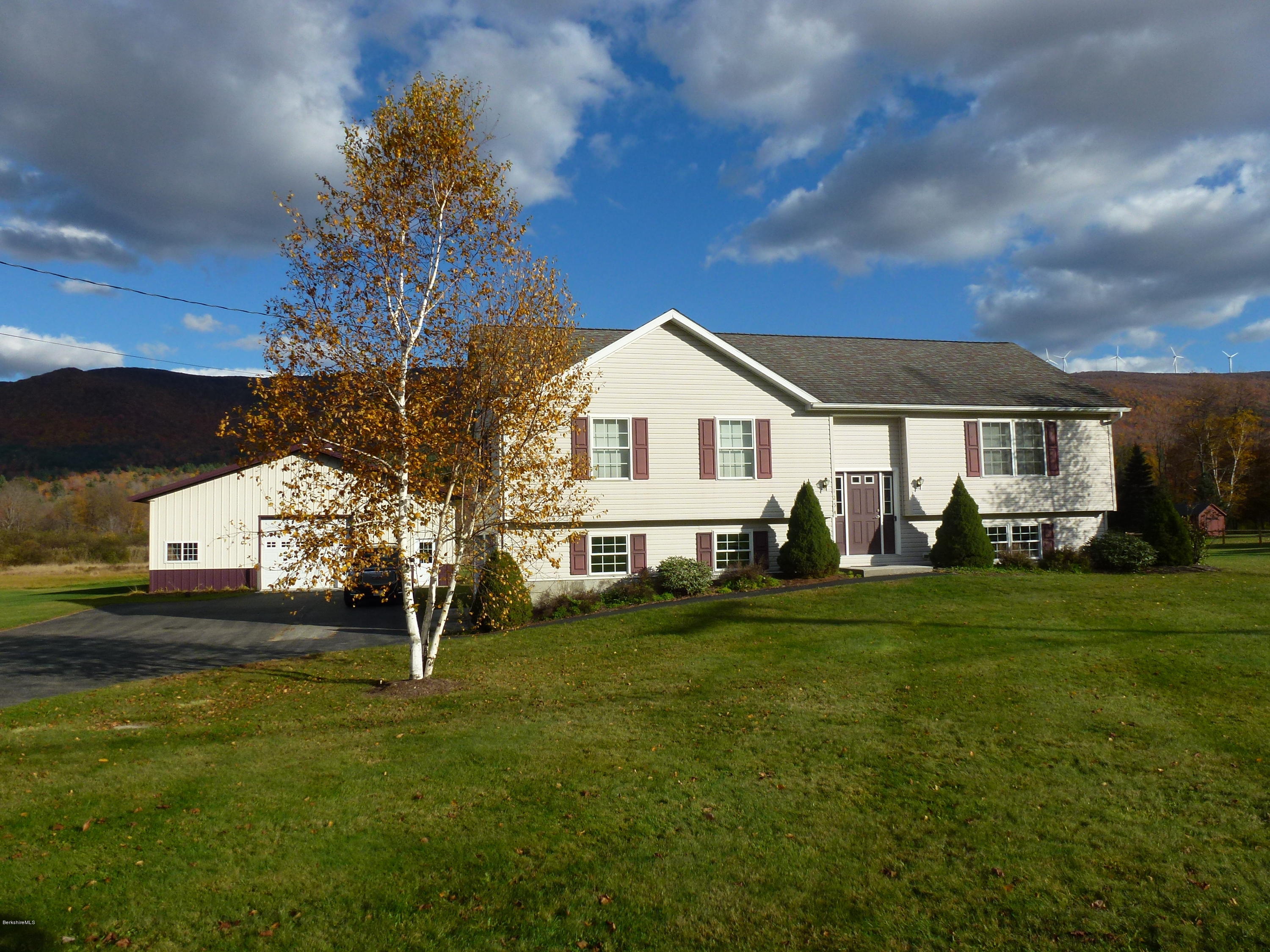 1254 Main Road Stamford, VT 05352 - Photo 1 of 39 a front view of a house with a garden