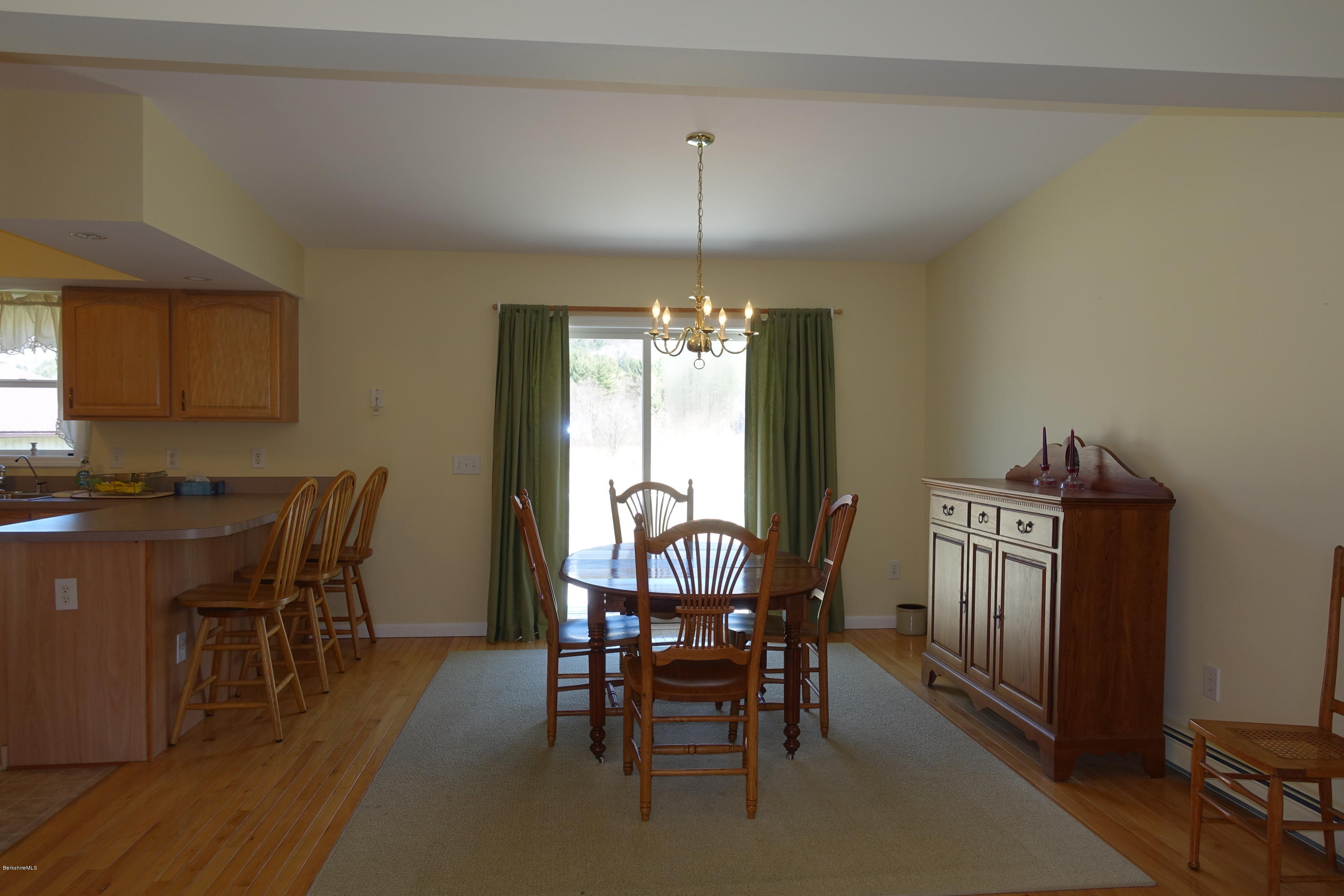 1254 Main Road Stamford, VT 05352 - Photo 19 of 39 a dining room with furniture a chandelier and wooden floor