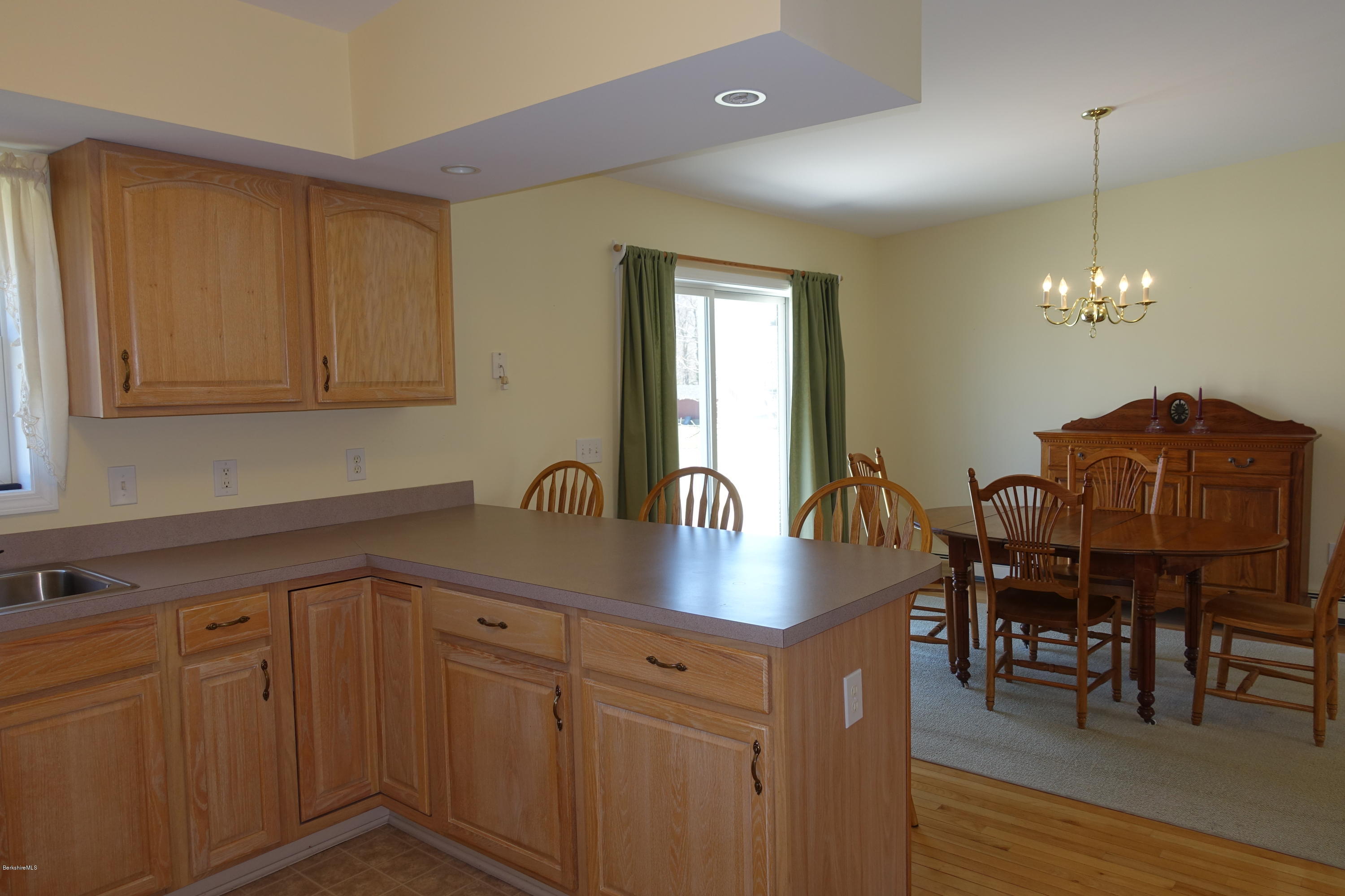 1254 Main Road Stamford, VT 05352 - Photo 22 of 39 a kitchen with cabinets table and chairs