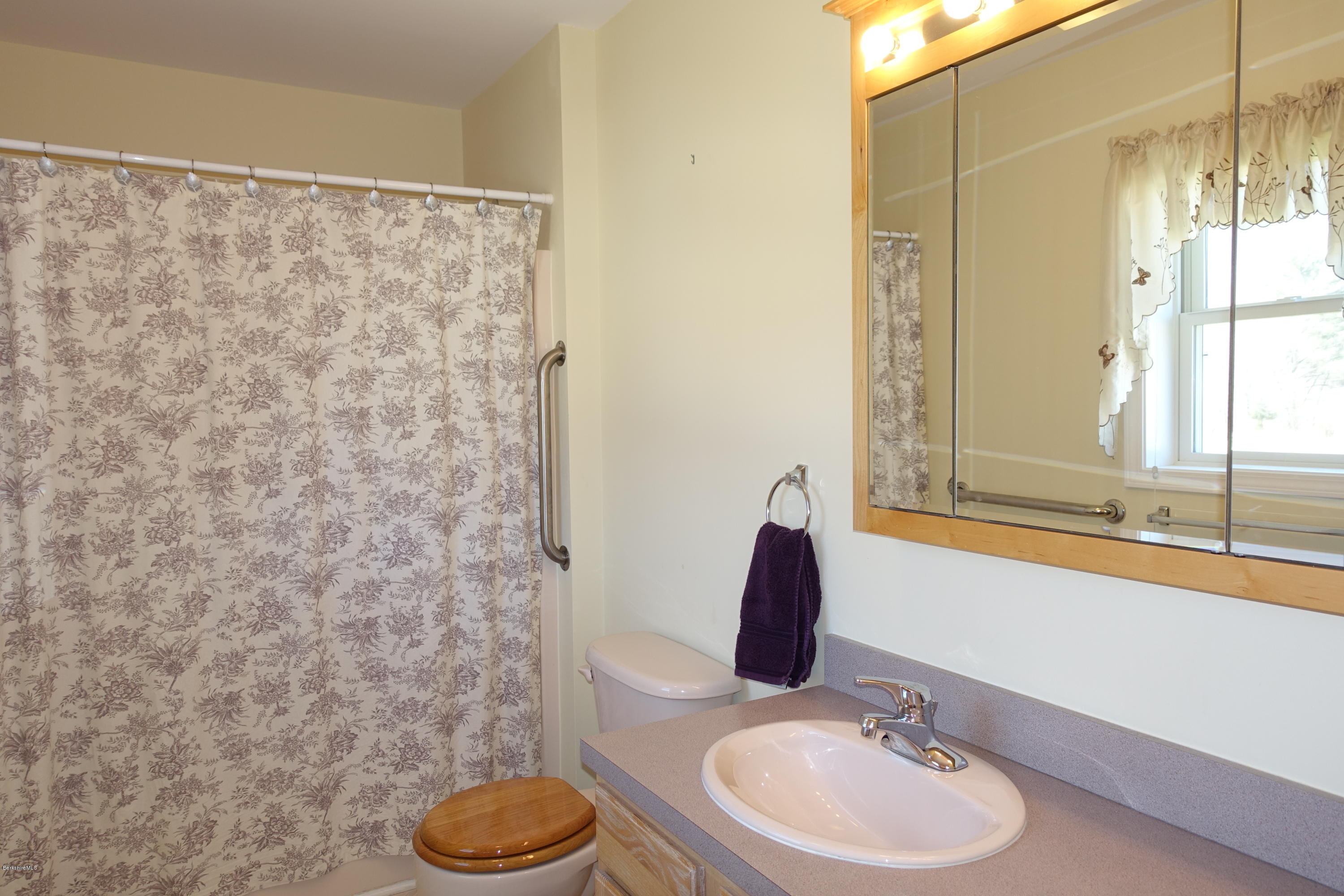 1254 Main Road Stamford, VT 05352 - Photo 24 of 39 a bathroom with a granite countertop sink and a mirror