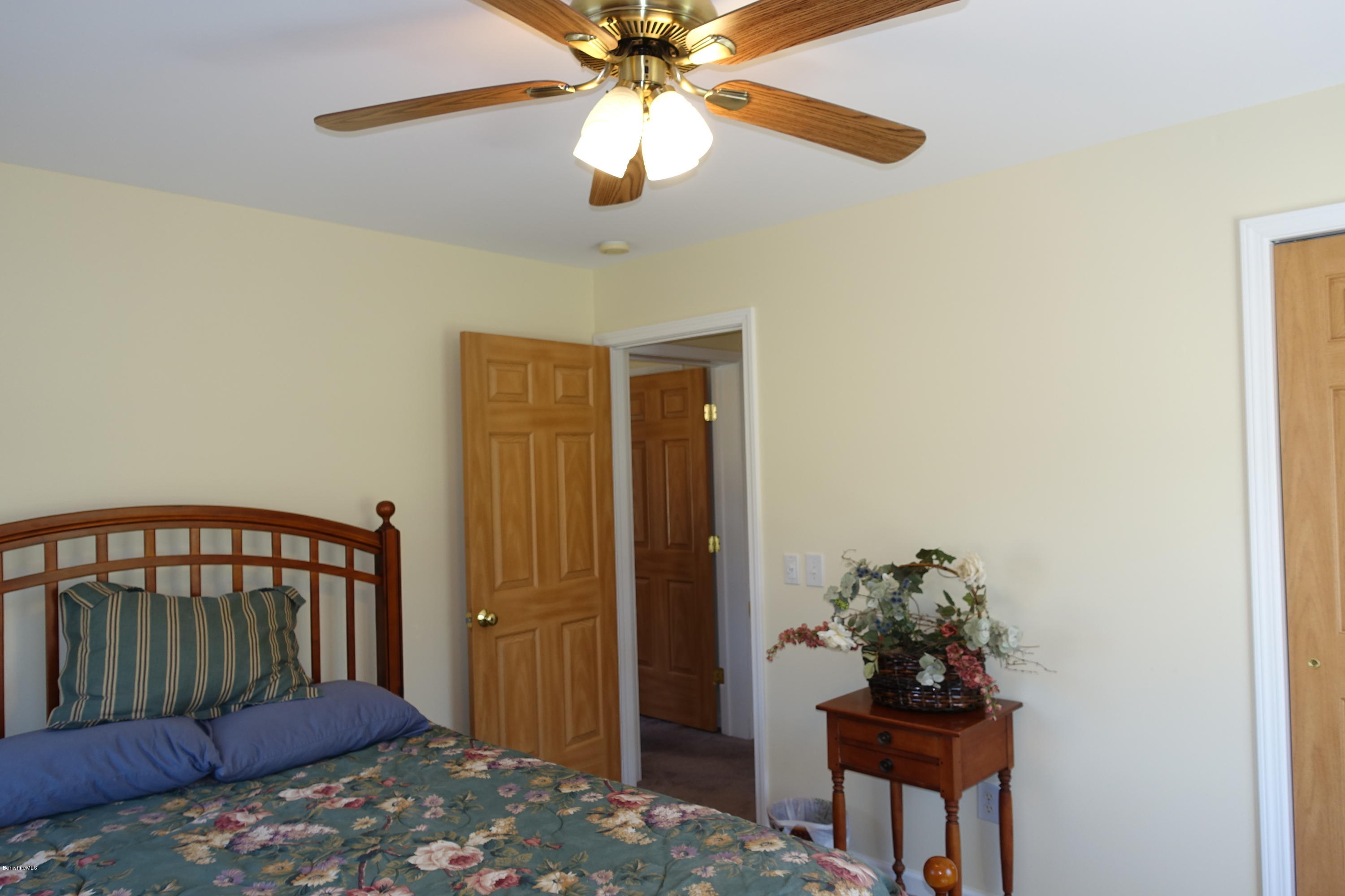 1254 Main Road Stamford, VT 05352 - Photo 26 of 39 a bedroom with a bed and a chandelier
