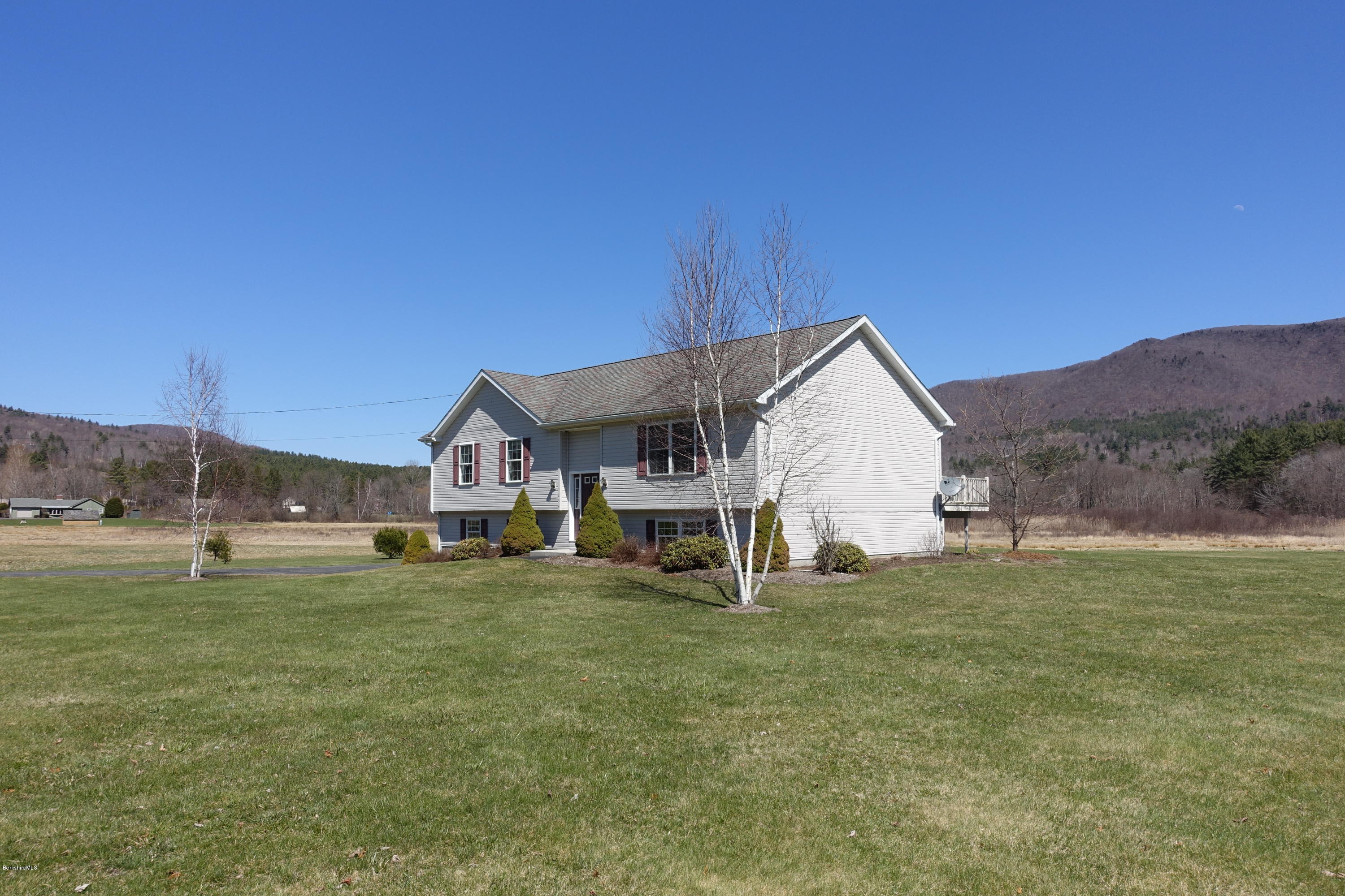1254 Main Road Stamford, VT 05352 - Photo 5 of 39 a big house with a big yard and large trees